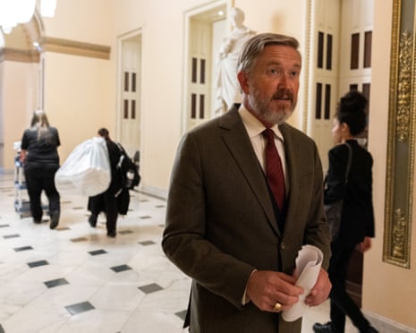 a man speaks in a corridor