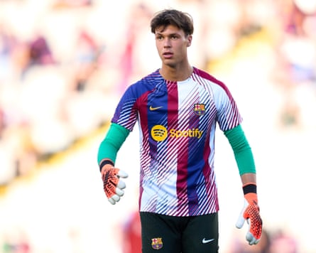 A young man in a multicolored football kit.